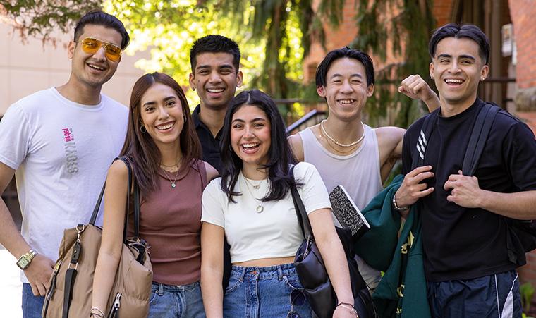 Admitted SPU students smile in front of McKinley Hall